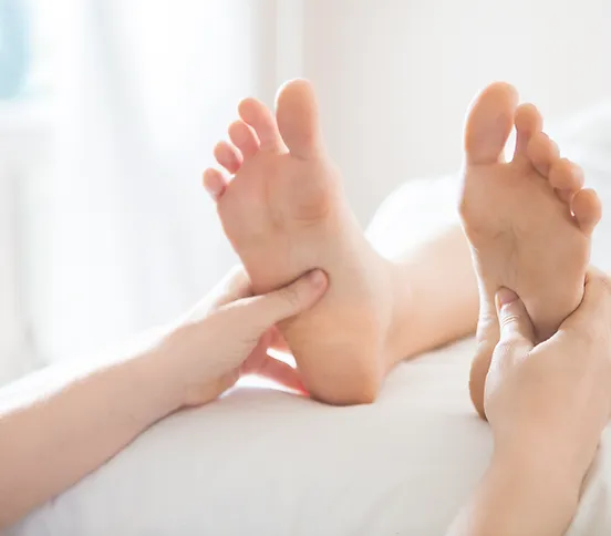 a person receiving a foot massage on a bed at Phanom Thai Massage 