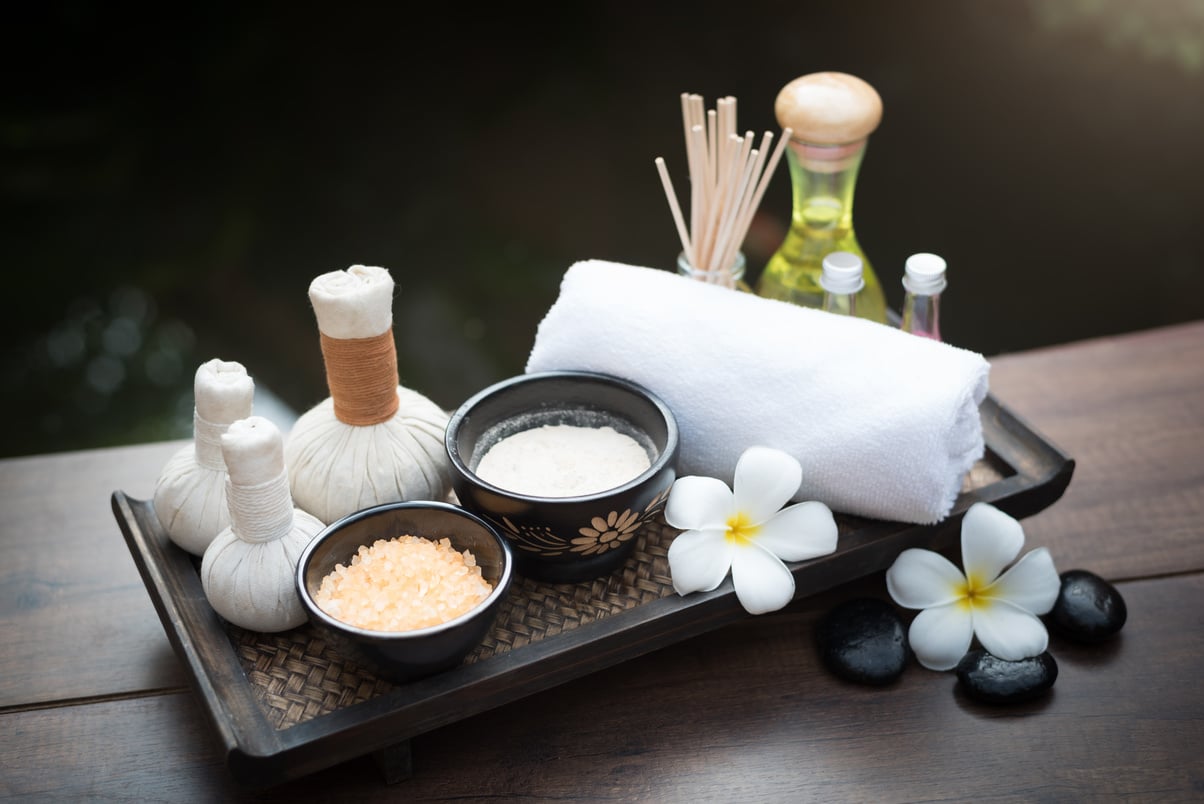 spa products on a wooden tray on a table